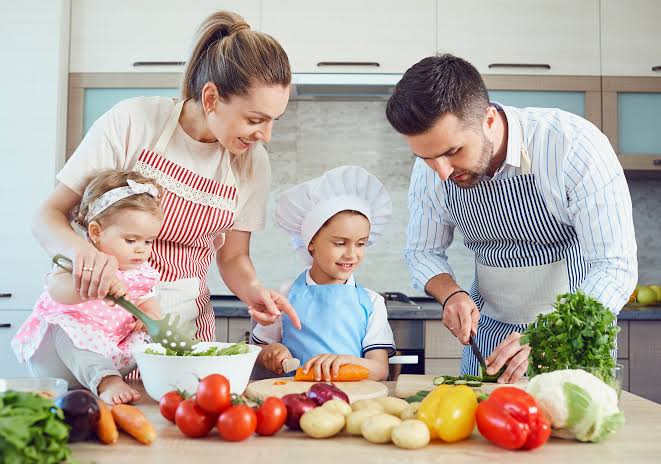 Family cooking together in a warm kitchen
